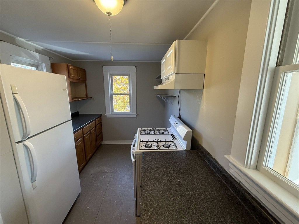 306 Franklin Road, Unit 2 Fitchburg, MA 01420 - Photo 3 of 17 a kitchen with a window a refrigerator and a stove