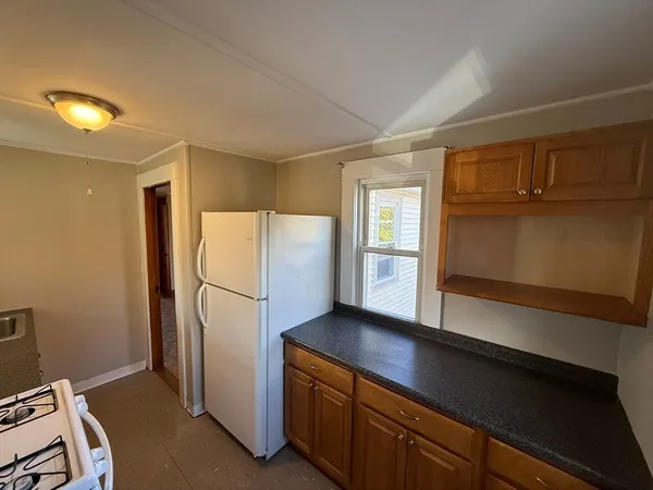 a kitchen with refrigerator cabinets and wooden floor