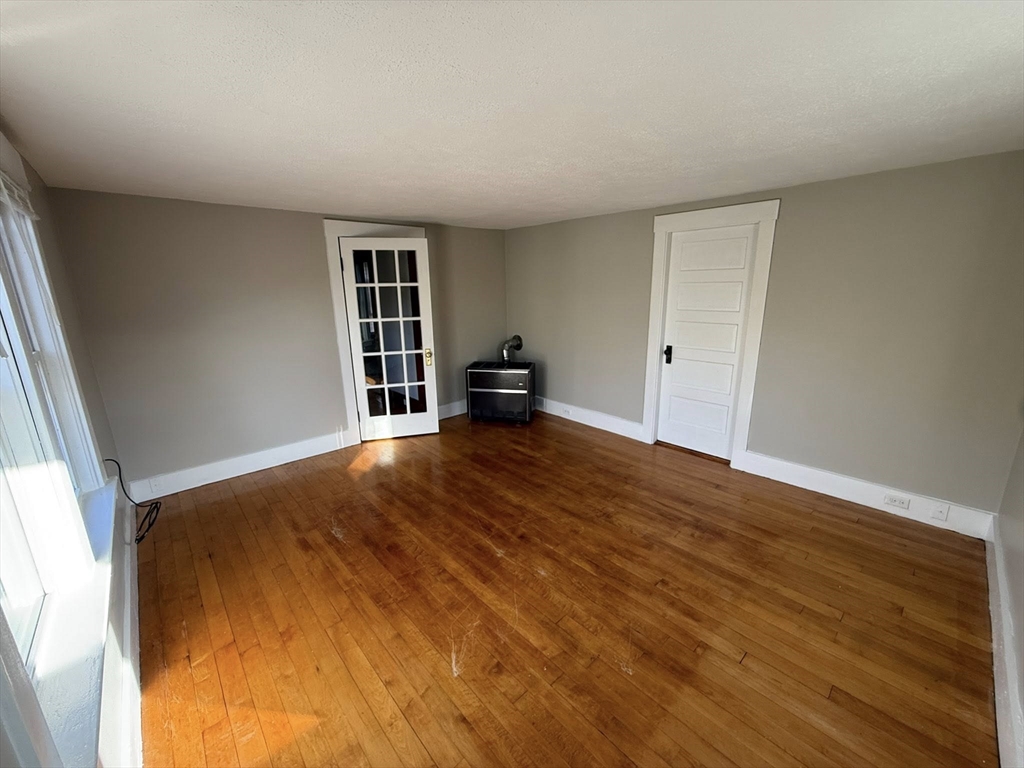 306 Franklin Road, Unit 2 Fitchburg, MA 01420 - Photo 6 of 17 a bedroom with a bed and wooden floor