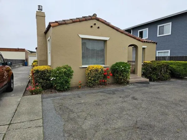 a front view of a house with garden