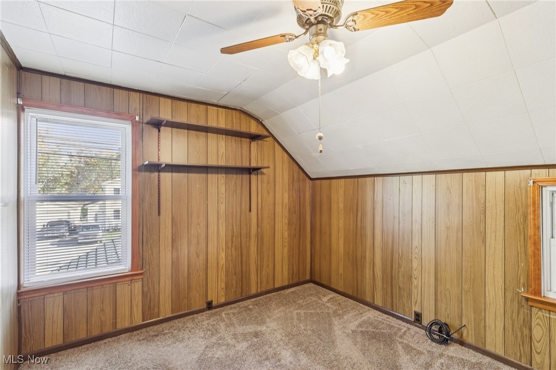6235 Jefferson Road Ashtabula, OH 44004 - Photo 25 of 40 Additional living space featuring wood walls, vaulted ceiling, light colored carpet, and ceiling fan