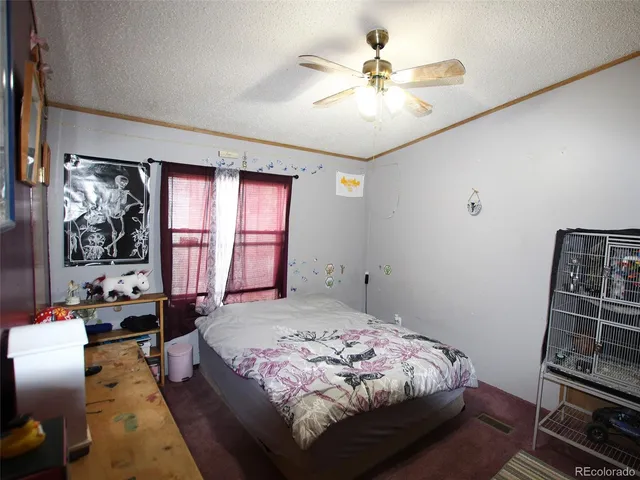 a bedroom with a bed next to a window