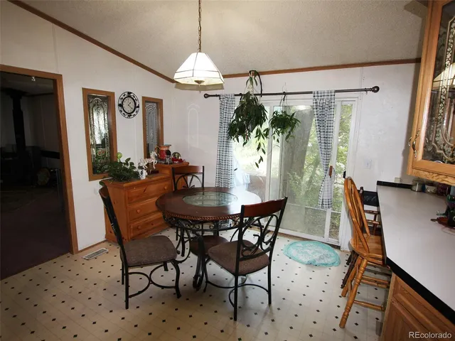 a view of a dining room with furniture and window