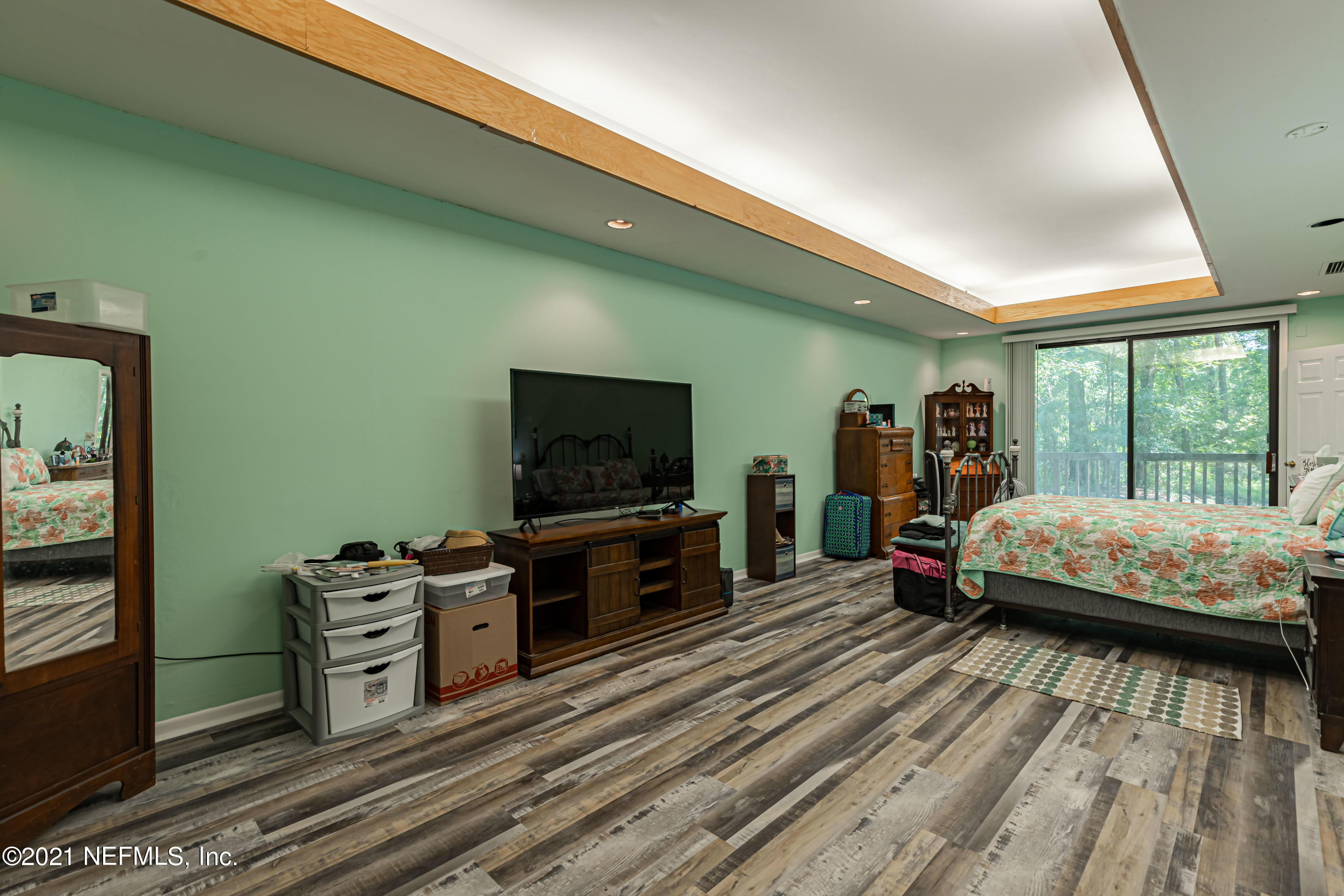 3155 Ravines Road, Unit 3502 Middleburg, FL 32068 - Photo 15 of 25 a living room with a bed furniture and a flat tv screen