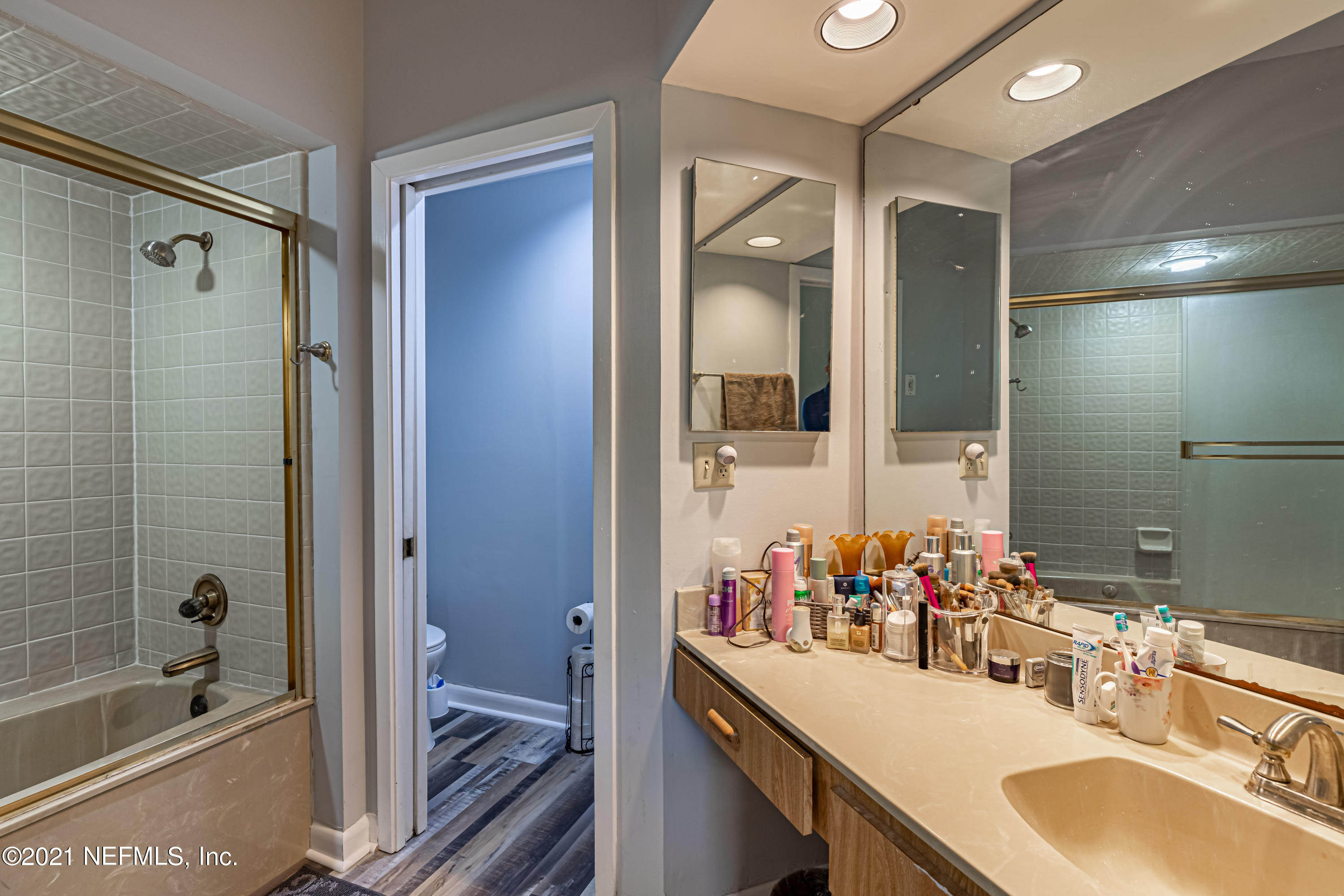 3155 Ravines Road, Unit 3502 Middleburg, FL 32068 - Photo 16 of 25 a bathroom with a tub sink and mirror