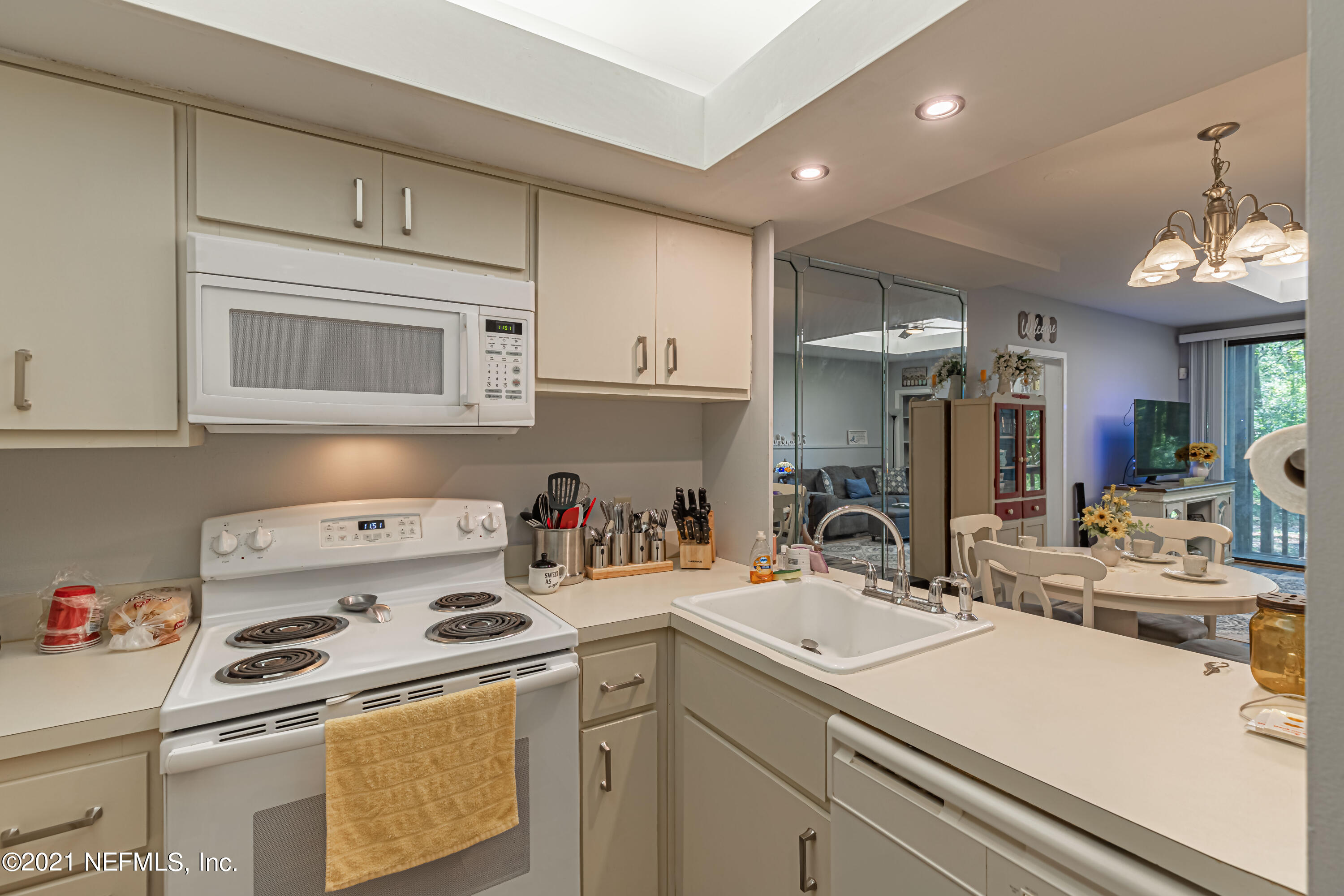 3155 Ravines Road, Unit 3502 Middleburg, FL 32068 - Photo 6 of 25 a kitchen with a sink a stove and cabinets