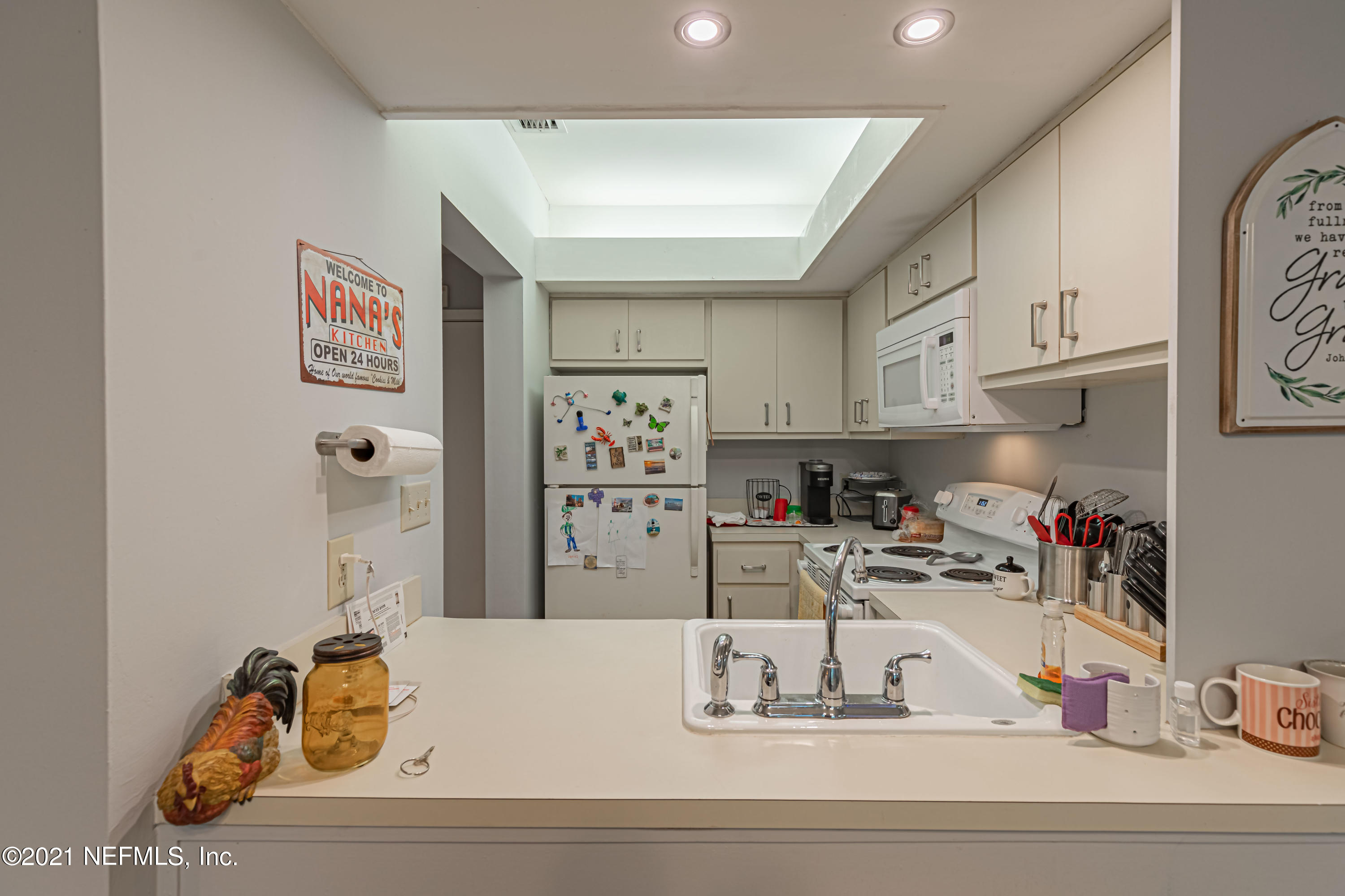 3155 Ravines Road, Unit 3502 Middleburg, FL 32068 - Photo 7 of 25 a kitchen with kitchen island a white counter top space cabinets and a sink