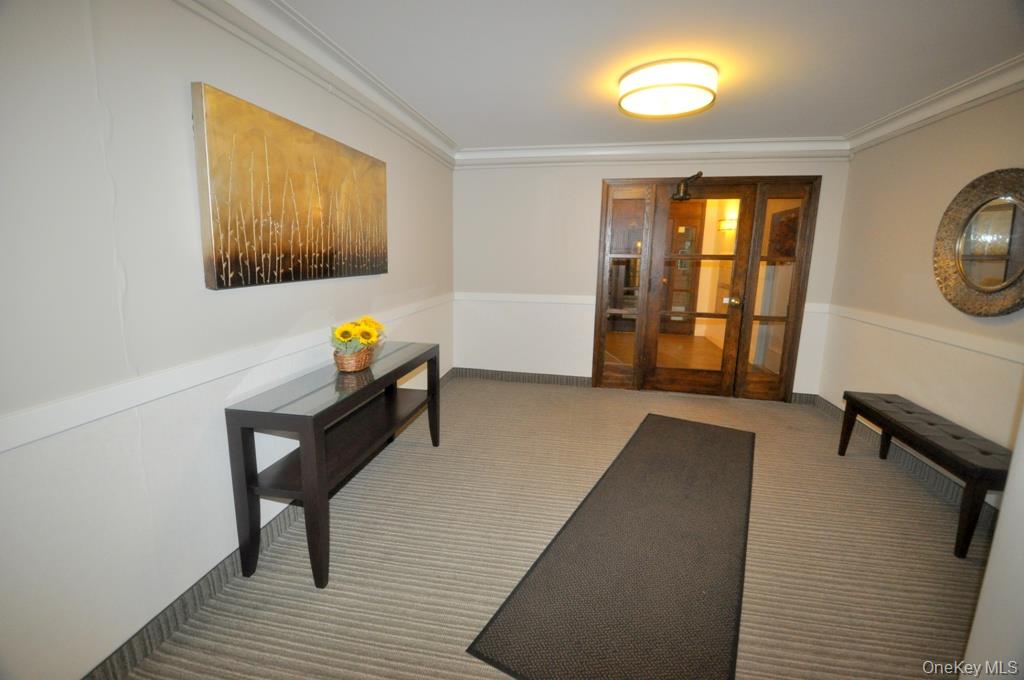 235 Garth Road, Unit A5B Scarsdale, NY 10583 - Photo 36 of 47 a living room with furniture and a window