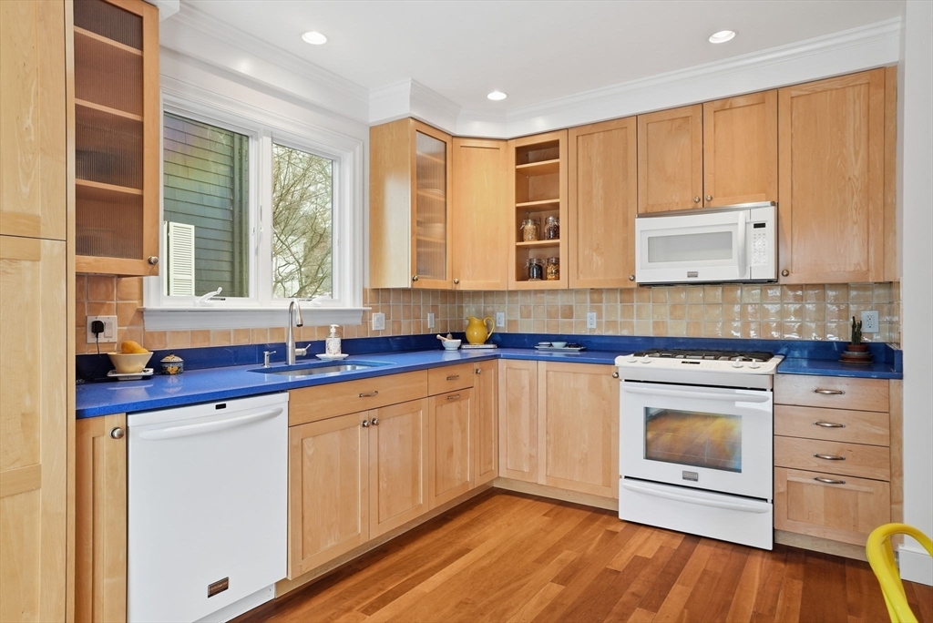 30 York Terrace Brookline, MA 02446 - Photo 11 of 39 a kitchen with stainless steel appliances granite countertop a stove a sink and a microwave