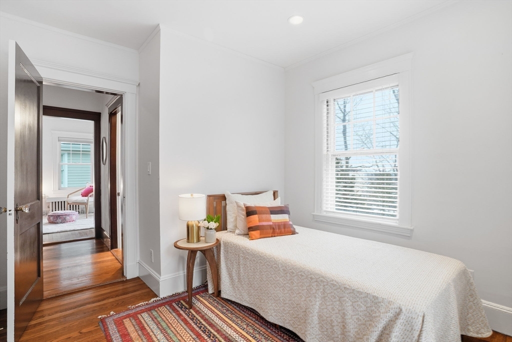 30 York Terrace Brookline, MA 02446 - Photo 29 of 39 a bedroom with a bed and wooden floor