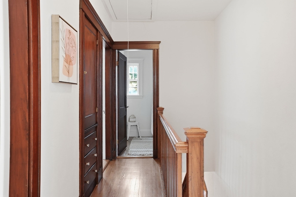 30 York Terrace Brookline, MA 02446 - Photo 32 of 39 a view of a hallway with wooden floor and staircase