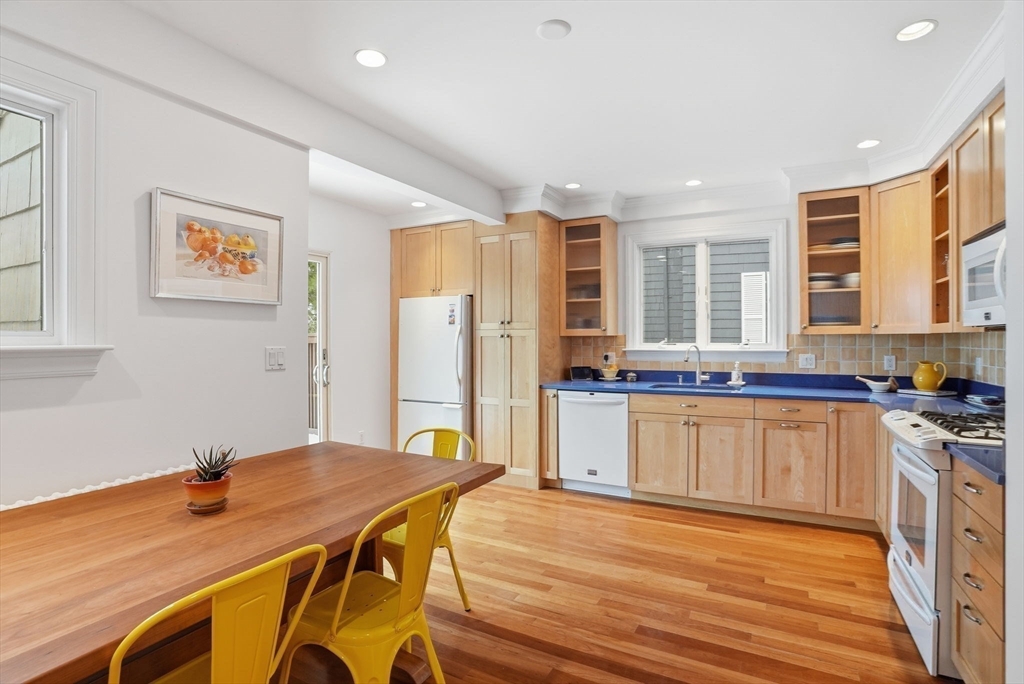 30 York Terrace Brookline, MA 02446 - Photo 10 of 39 a kitchen with stainless steel appliances granite countertop a sink dishwasher a refrigerator and a stove with wooden floor