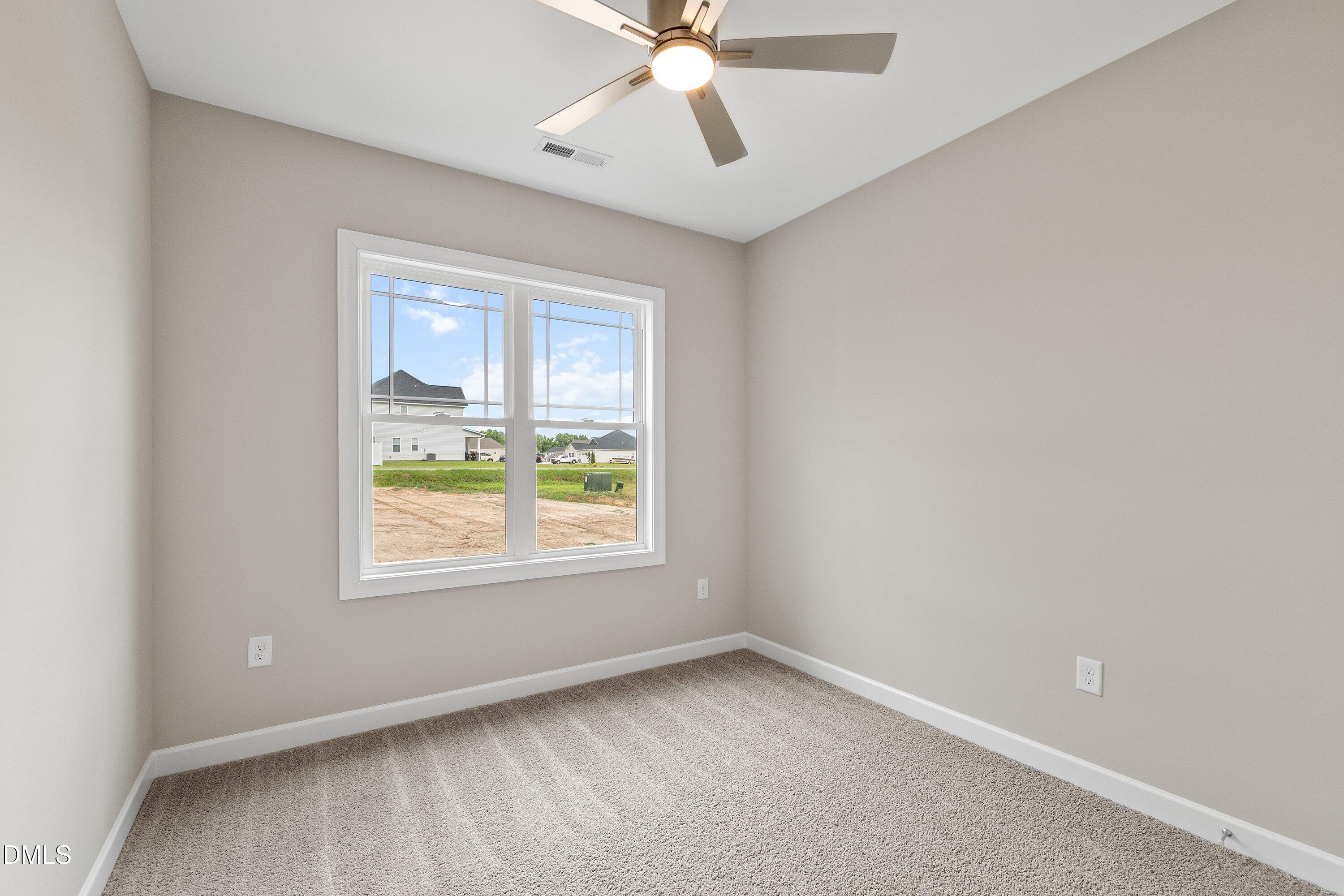 1115 Nor-Am Road Pikeville, NC 27863 - Photo 20 of 40 an empty room with a window and a fan