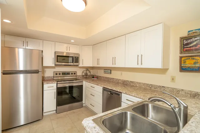 a kitchen with a sink and a stove top oven