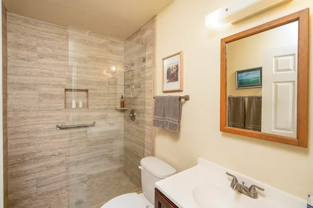 a living room with furniture and a ceiling fan