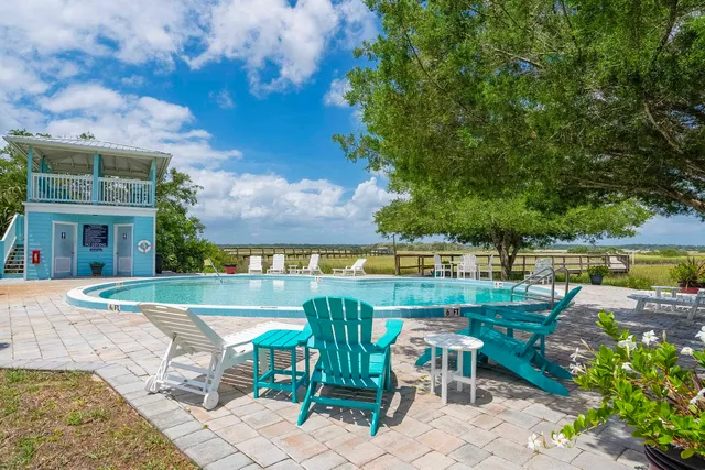 a view of a chairs and table in the balcony