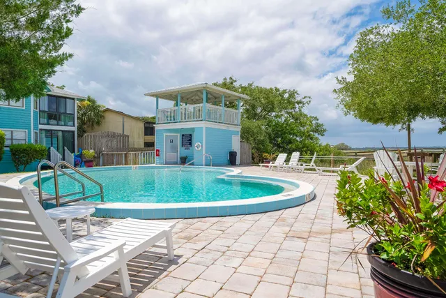 a view of a chairs and table in the balcony