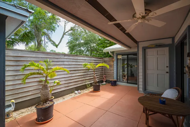 a view of a patio with table and chairs next to a yard