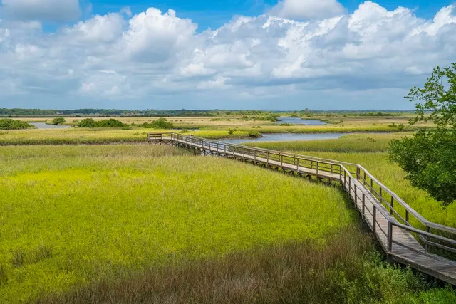 a view of a city with an ocean and mountain view in back