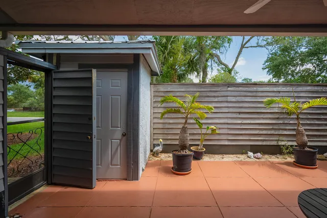a living room with furniture and a ceiling fan