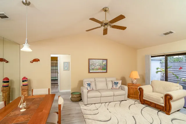 a living room with furniture and kitchen view