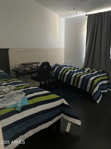 a bed sitting in a bedroom next to a window