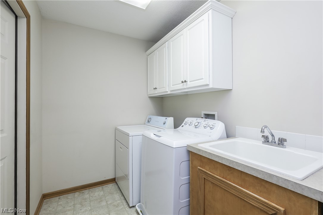 5951 Wentworth Road Southwest Canton, OH 44706 - Photo 21 of 33 2nd floor laundry with a door to a secret storage space!