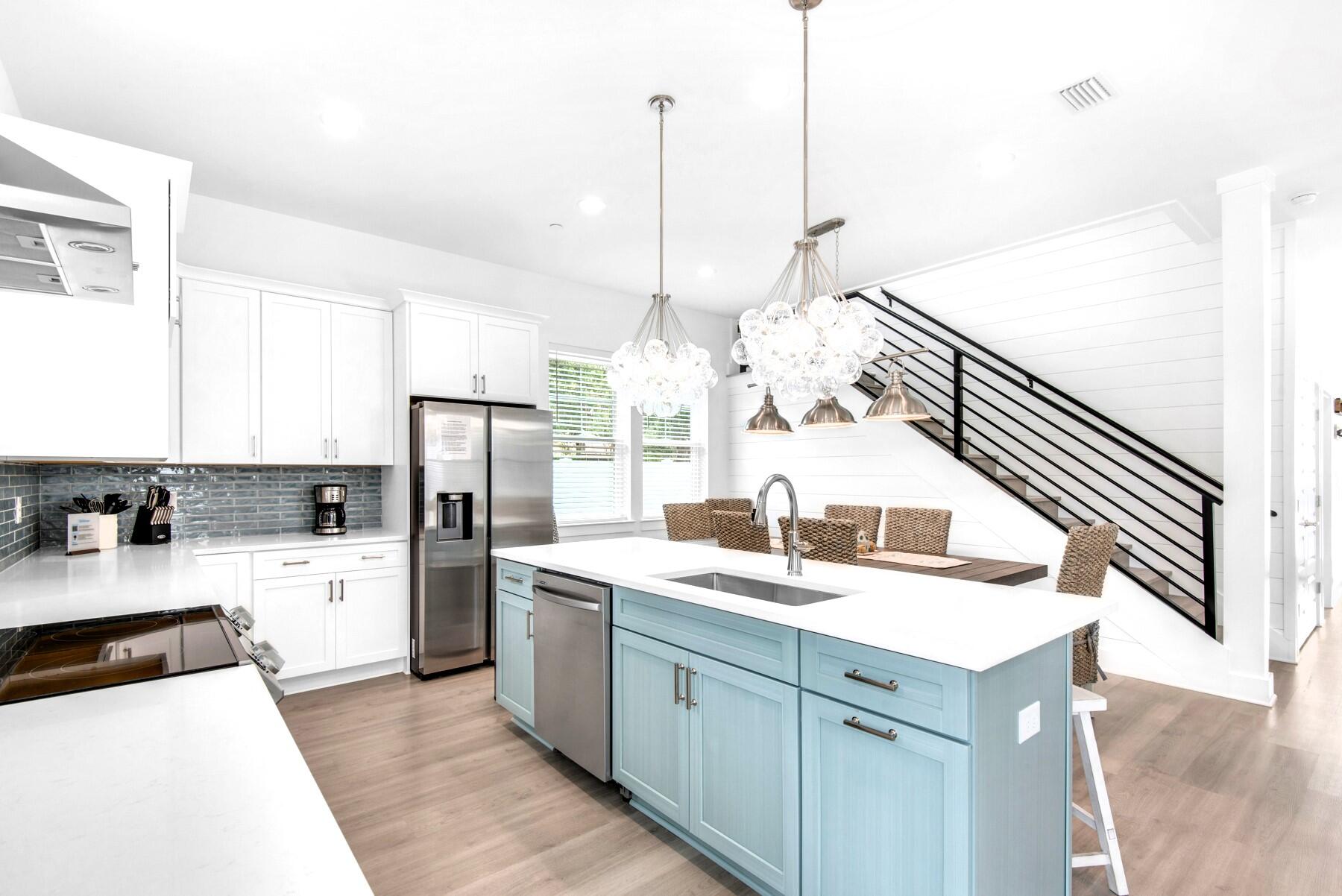 4543 Luke Avenue Destin, FL 32541 - Photo 14 of 45 a kitchen with a sink a center island and stainless steel appliances