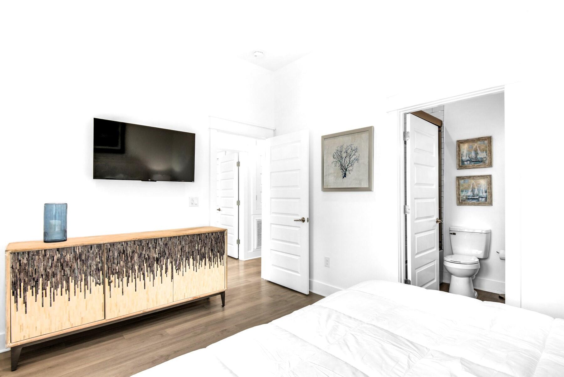 4543 Luke Avenue Destin, FL 32541 - Photo 16 of 45 a bedroom with a bed and a flat screen tv