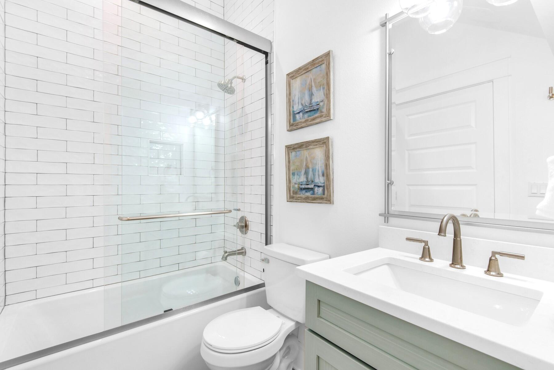 4543 Luke Avenue Destin, FL 32541 - Photo 17 of 45 a bathroom with a sink a toilet and shower