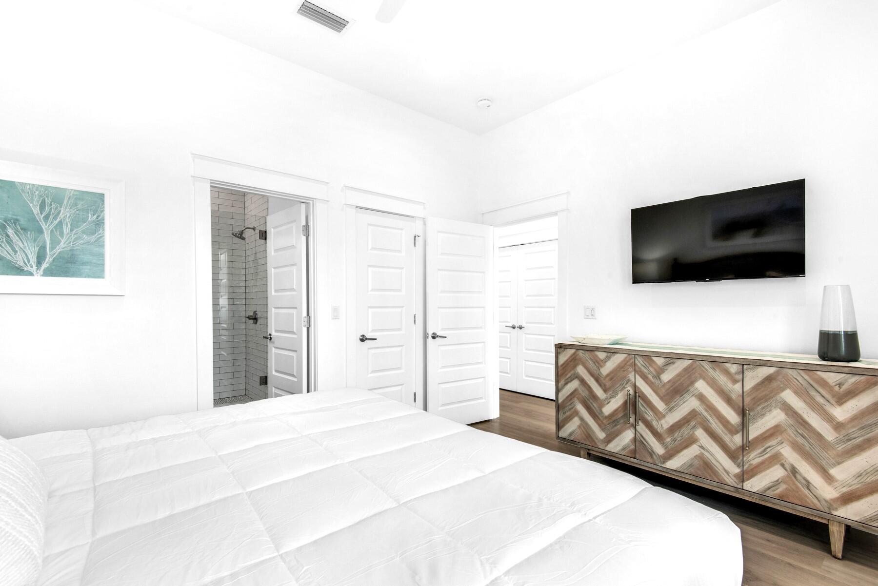 4543 Luke Avenue Destin, FL 32541 - Photo 19 of 45 a bedroom with a bed and a flat screen tv