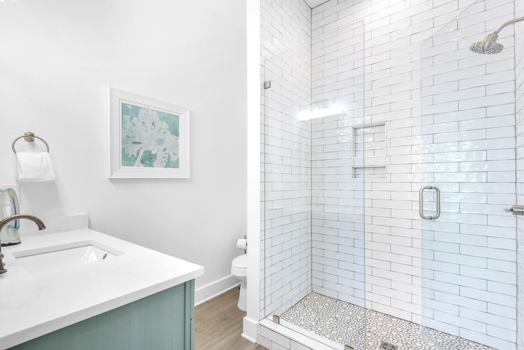 4543 Luke Avenue Destin, FL 32541 - Photo 20 of 45 a bathroom with a sink a toilet and shower