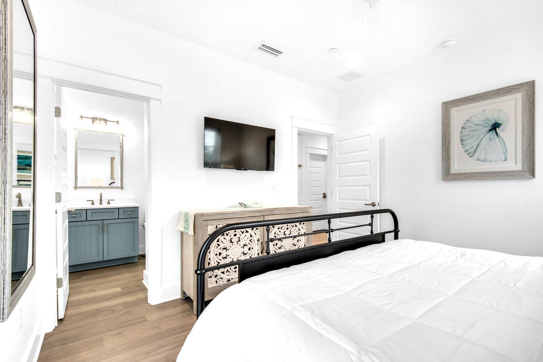 4543 Luke Avenue Destin, FL 32541 - Photo 24 of 45 a bedroom with a bed and a flat screen tv