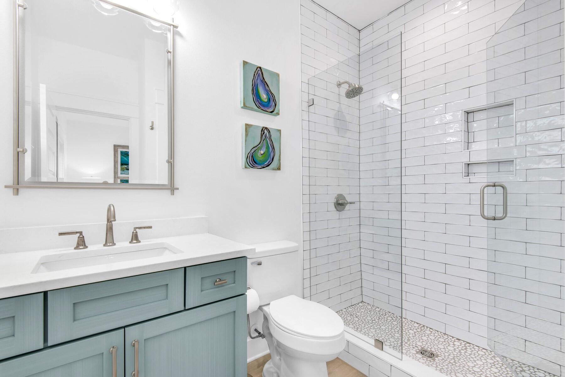 4543 Luke Avenue Destin, FL 32541 - Photo 25 of 45 a bathroom with a shower sink vanity mirror and toilet