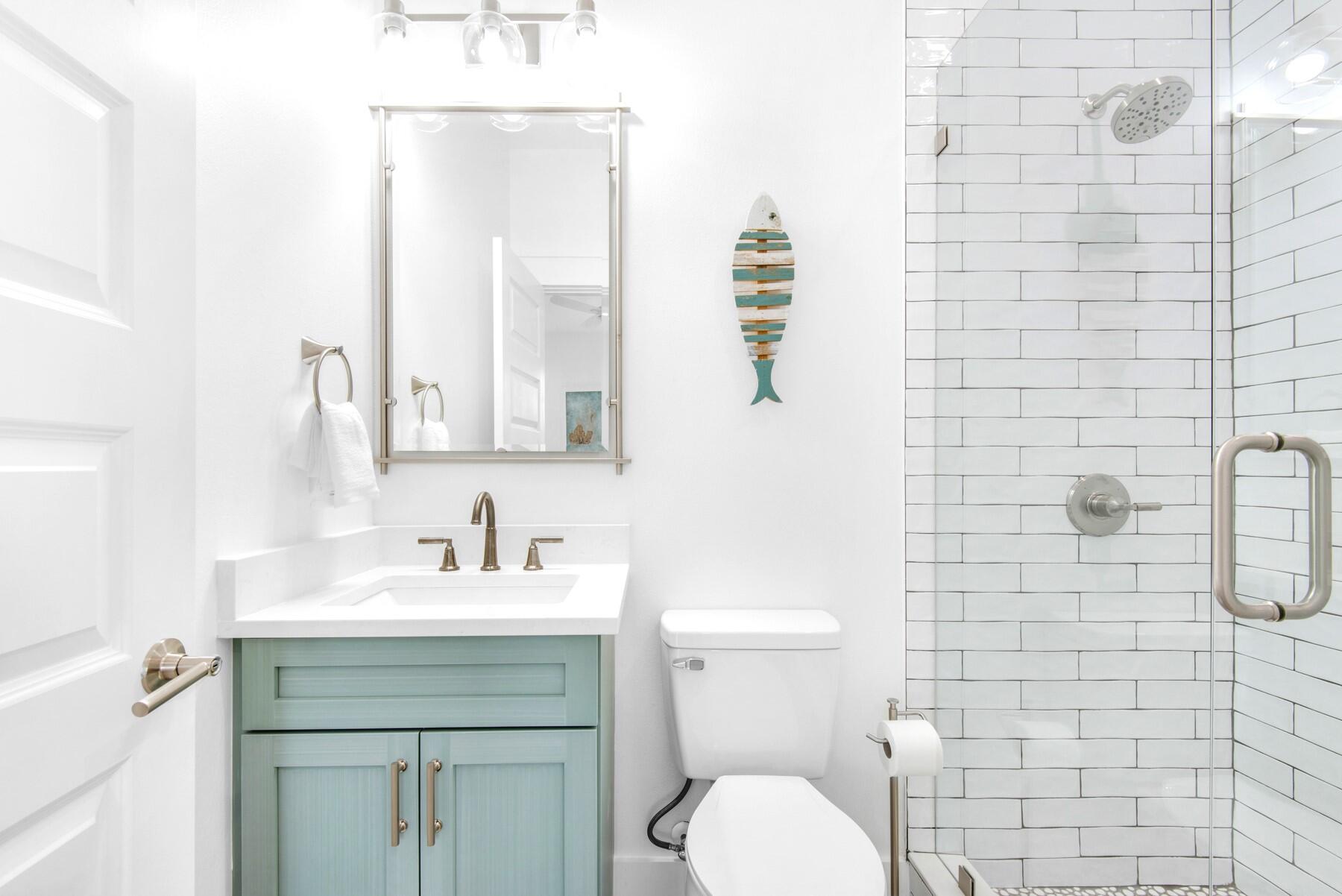 4543 Luke Avenue Destin, FL 32541 - Photo 32 of 45 a bathroom with a toilet sink vanity and mirror