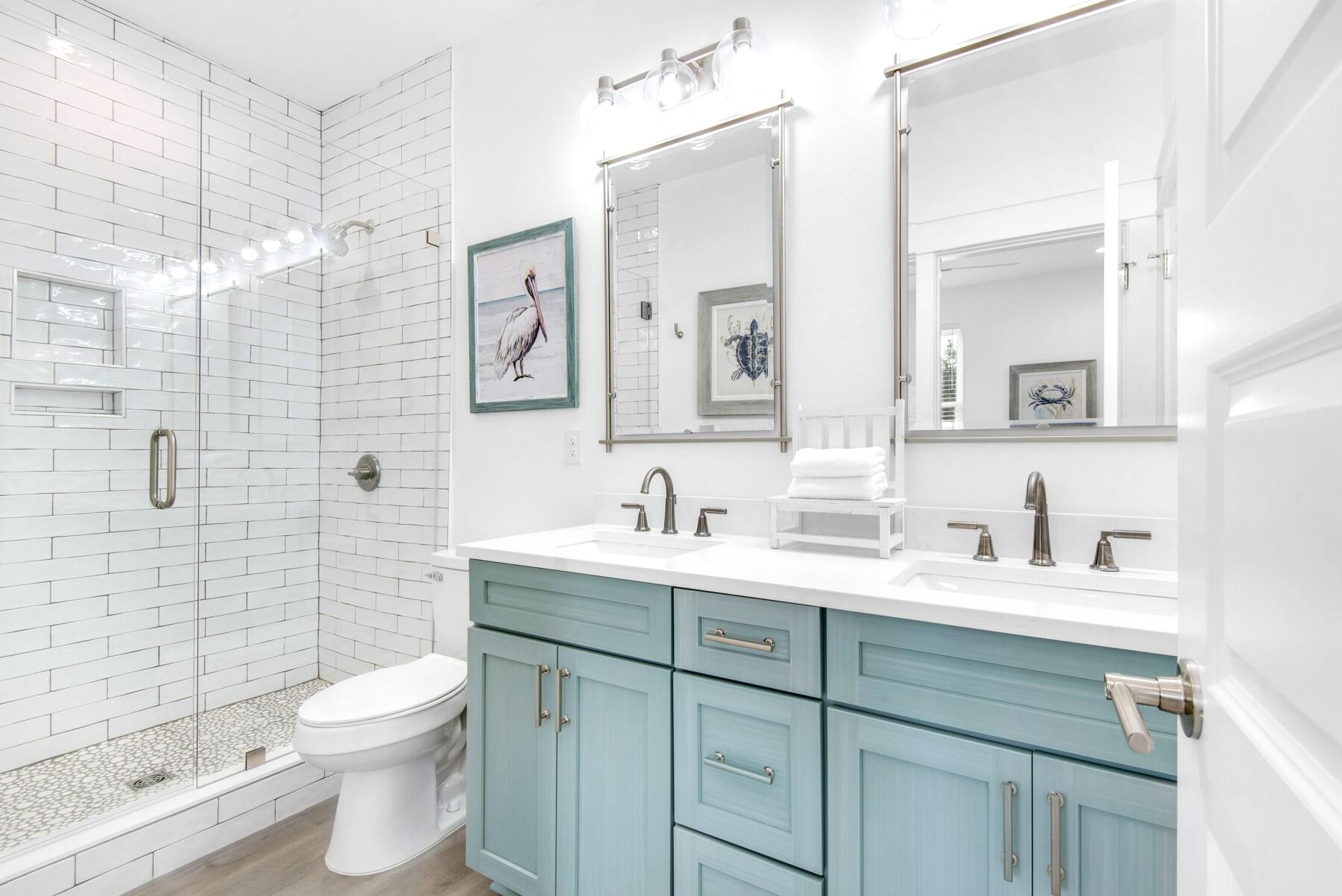 4543 Luke Avenue Destin, FL 32541 - Photo 35 of 45 a bathroom with a toilet sink vanity and mirror