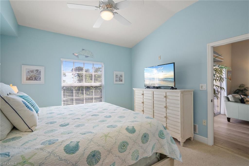 4455 Botanical Pl Circle, Unit 405 Naples, FL 34112 - Photo 11 of 46 a bedroom with a bed and a flat screen tv
