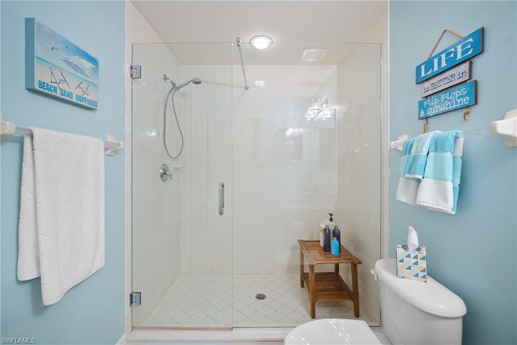4455 Botanical Pl Circle, Unit 405 Naples, FL 34112 - Photo 12 of 46 a bathroom with a shower a toilet and a sink