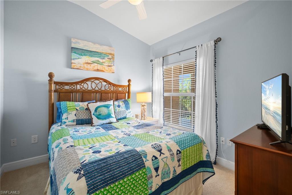 4455 Botanical Pl Circle, Unit 405 Naples, FL 34112 - Photo 13 of 46 a bedroom with a bed window and flat screen tv