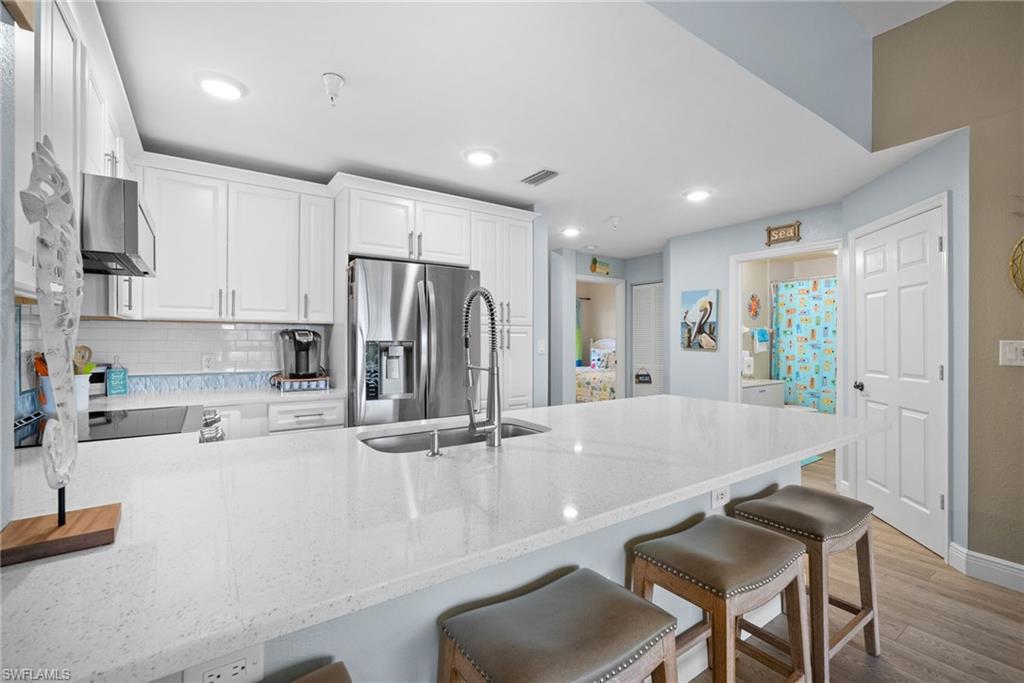 4455 Botanical Pl Circle, Unit 405 Naples, FL 34112 - Photo 20 of 46 a view of kitchen with stainless steel appliances granite countertop a sink and cabinets