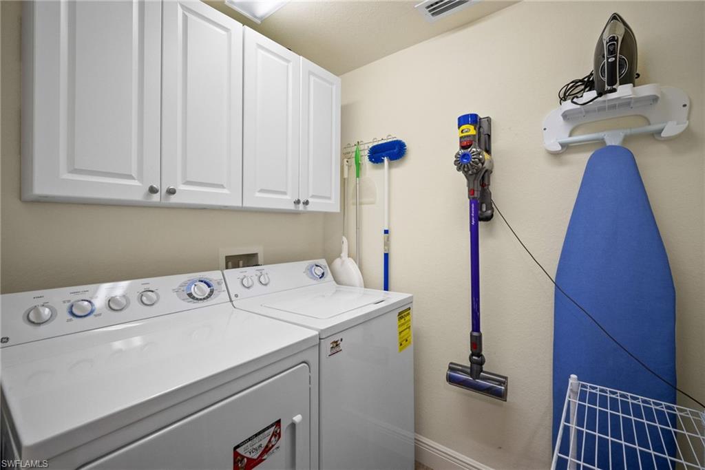 4455 Botanical Pl Circle, Unit 405 Naples, FL 34112 - Photo 26 of 46 a utility room with dryer and washer