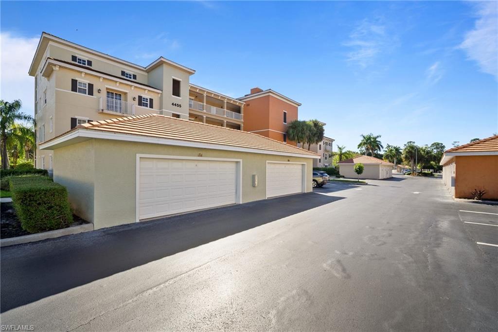 4455 Botanical Pl Circle, Unit 405 Naples, FL 34112 - Photo 27 of 46 a large building with a street