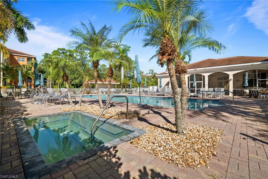 4455 Botanical Pl Circle, Unit 405 Naples, FL 34112 - Photo 34 of 46 a view of a swimming pool with a patio