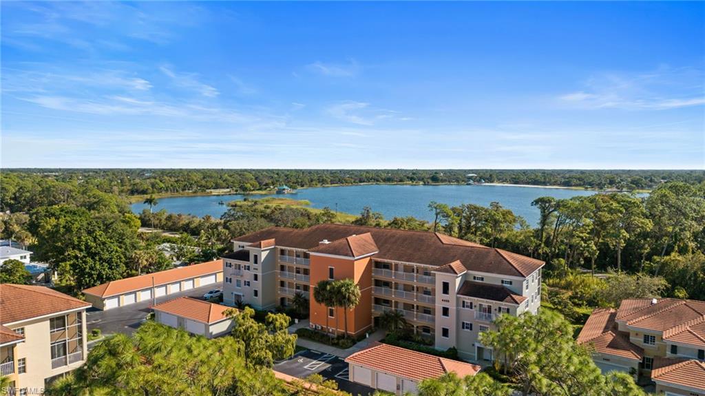 4455 Botanical Pl Circle, Unit 405 Naples, FL 34112 - Photo 45 of 46 an aerial view of a house with a lake view