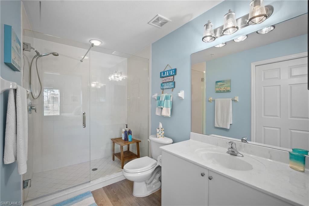 4455 Botanical Pl Circle, Unit 405 Naples, FL 34112 - Photo 8 of 46 a bathroom with a sink toilet and shower