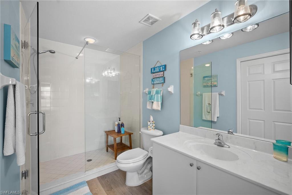 4455 Botanical Pl Circle, Unit 405 Naples, FL 34112 - Photo 10 of 46 a bathroom with a sink toilet and shower