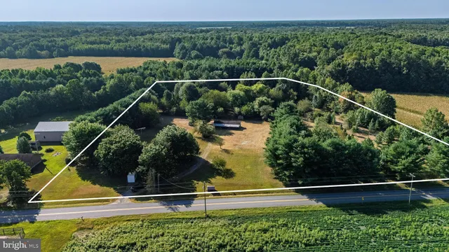 an aerial view of house with yard swimming pool and outdoor seating