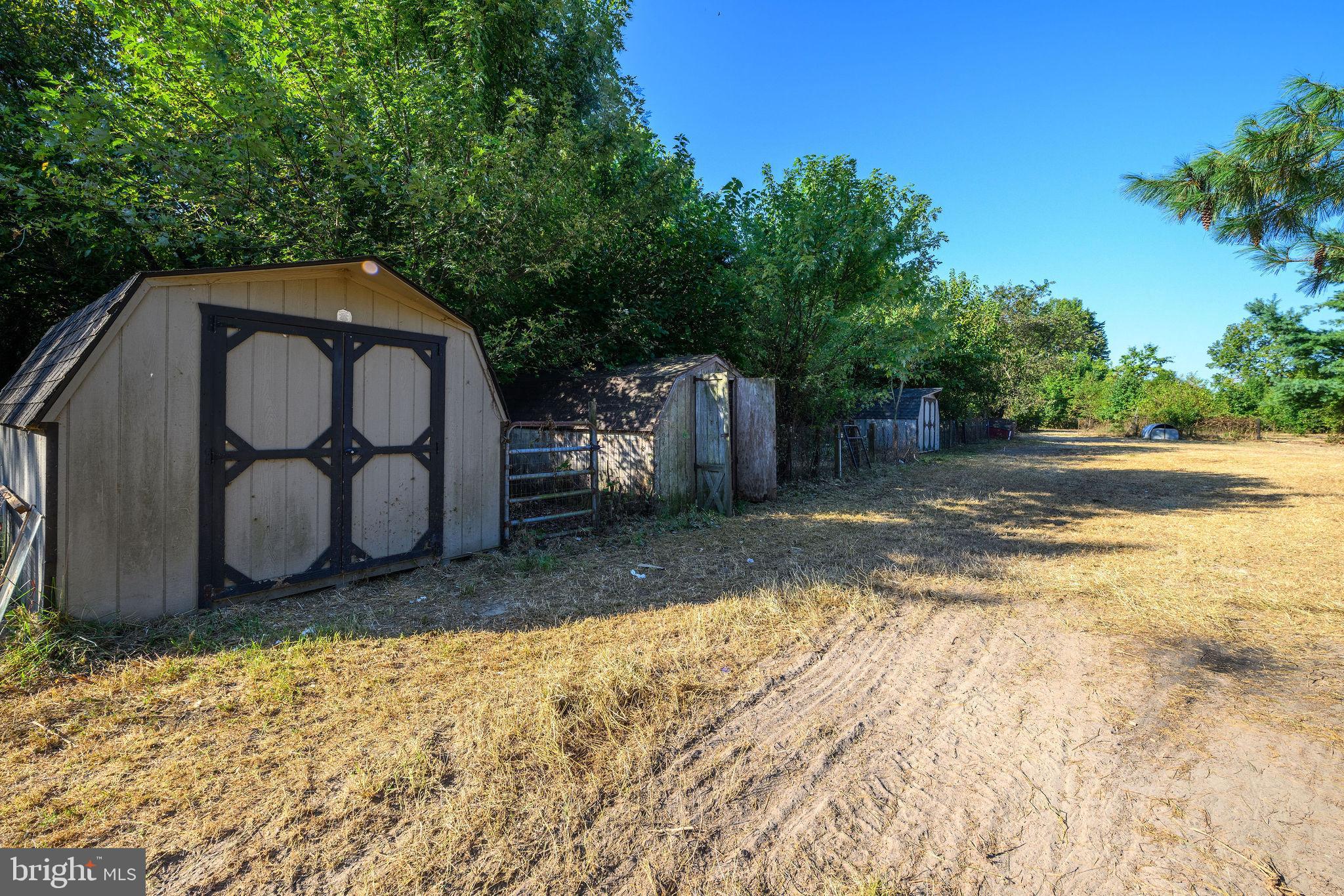 3182 Gun And Rod Club Road Houston, DE 19954 - Photo 21 of 32 a backyard of a house with large trees and wooden fence
