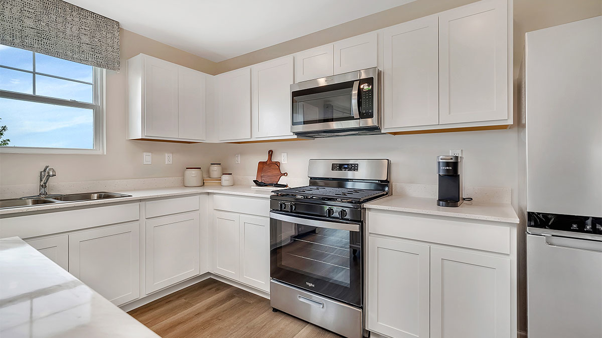 6719 Applegate Drive Plainfield, IL 60586 - Photo 25 of 39 a kitchen with white cabinets stainless steel appliances and sink