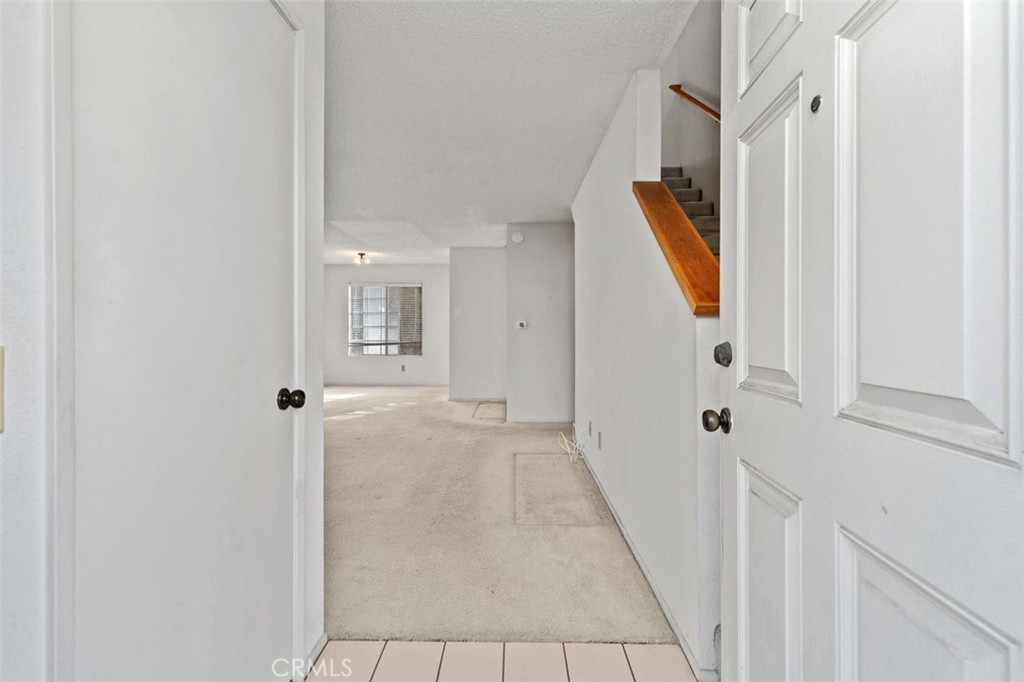 2800 Plaza Del Amo, Unit 375 Torrance, CA 90503 - Photo 3 of 24 a view of a hallway with white walls and stairs